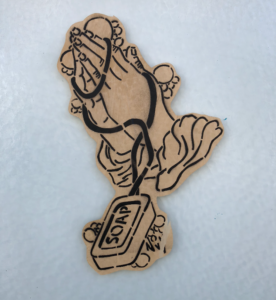 A stenciled print of praying hands wrapped in string attached to a bar of soap.