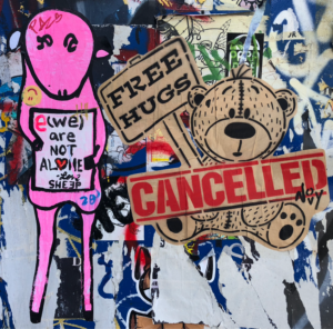 Prints of a pink sheeplike character holding a sign saying "E(we) are not alone" and a teddy bear holding a sign that says "FREE HUGS" with "CANCELLED" stamped over it.