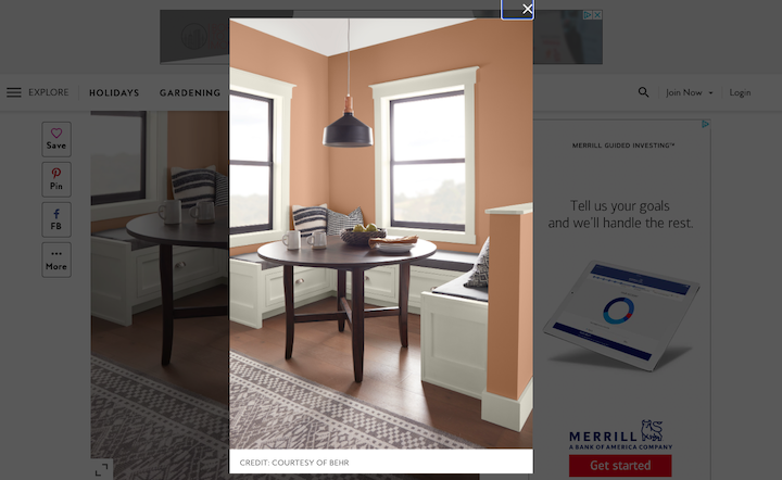 Screenshot from Better Homes and Gardens featuring a subtle earthy orange paint on the walls of a minimal dining room